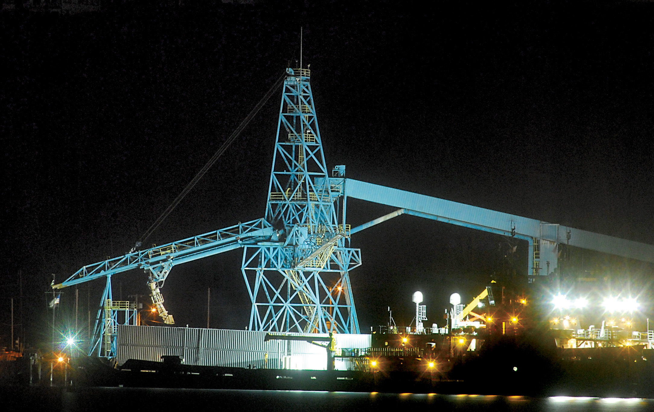 The chip loader at the Port of Port Angeles Terminal 7 on Port Angeles Harbor is illuminated in this 2011 file photo. — Keith Thorpe/Peninsula Daily News