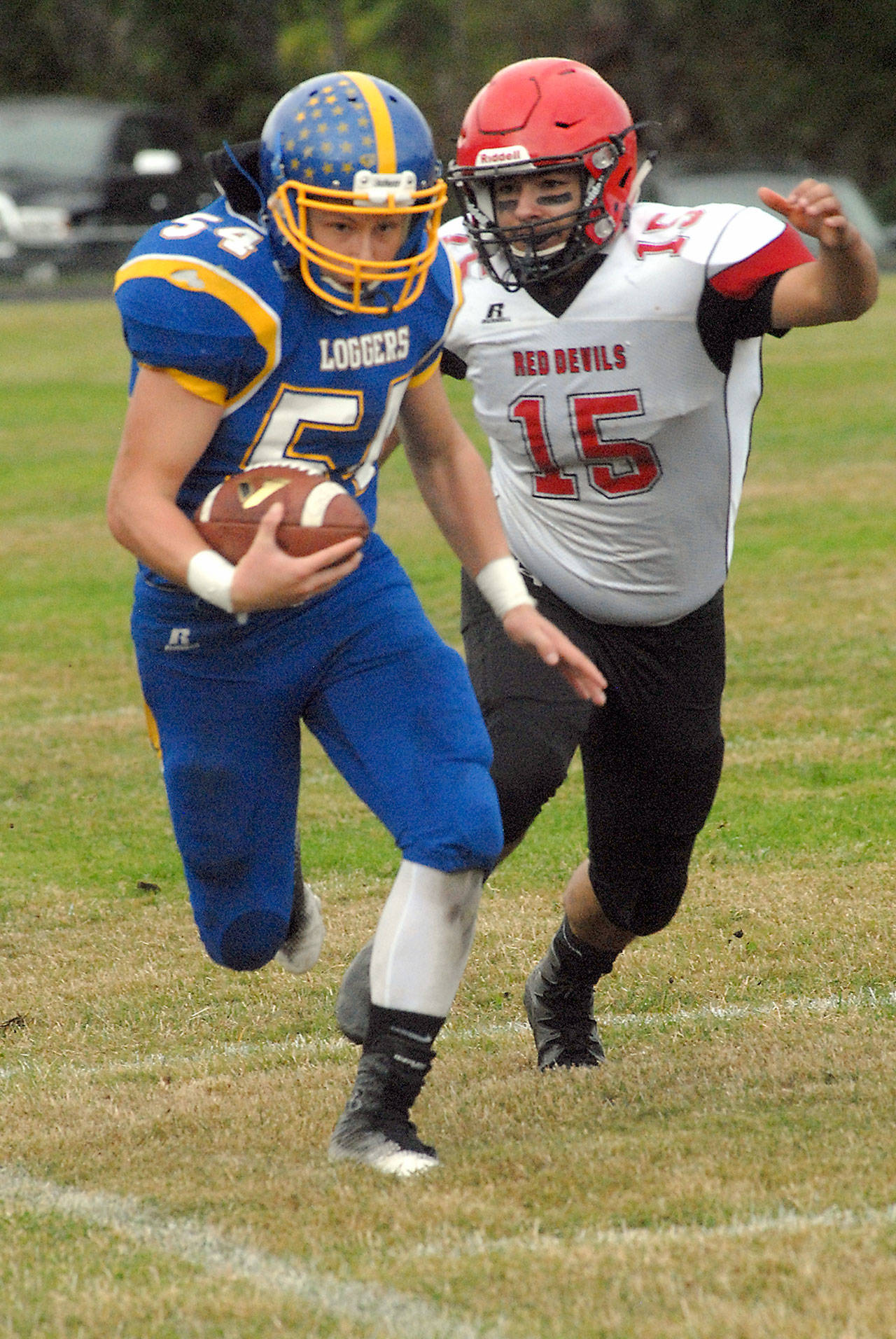 Crescent’s Noah Leonard is pursued by Neah Bay’s Joseph Yallup in a game played on Sept. 30 in Joyce.                                Keith Thorpe/Peninsula Daily News