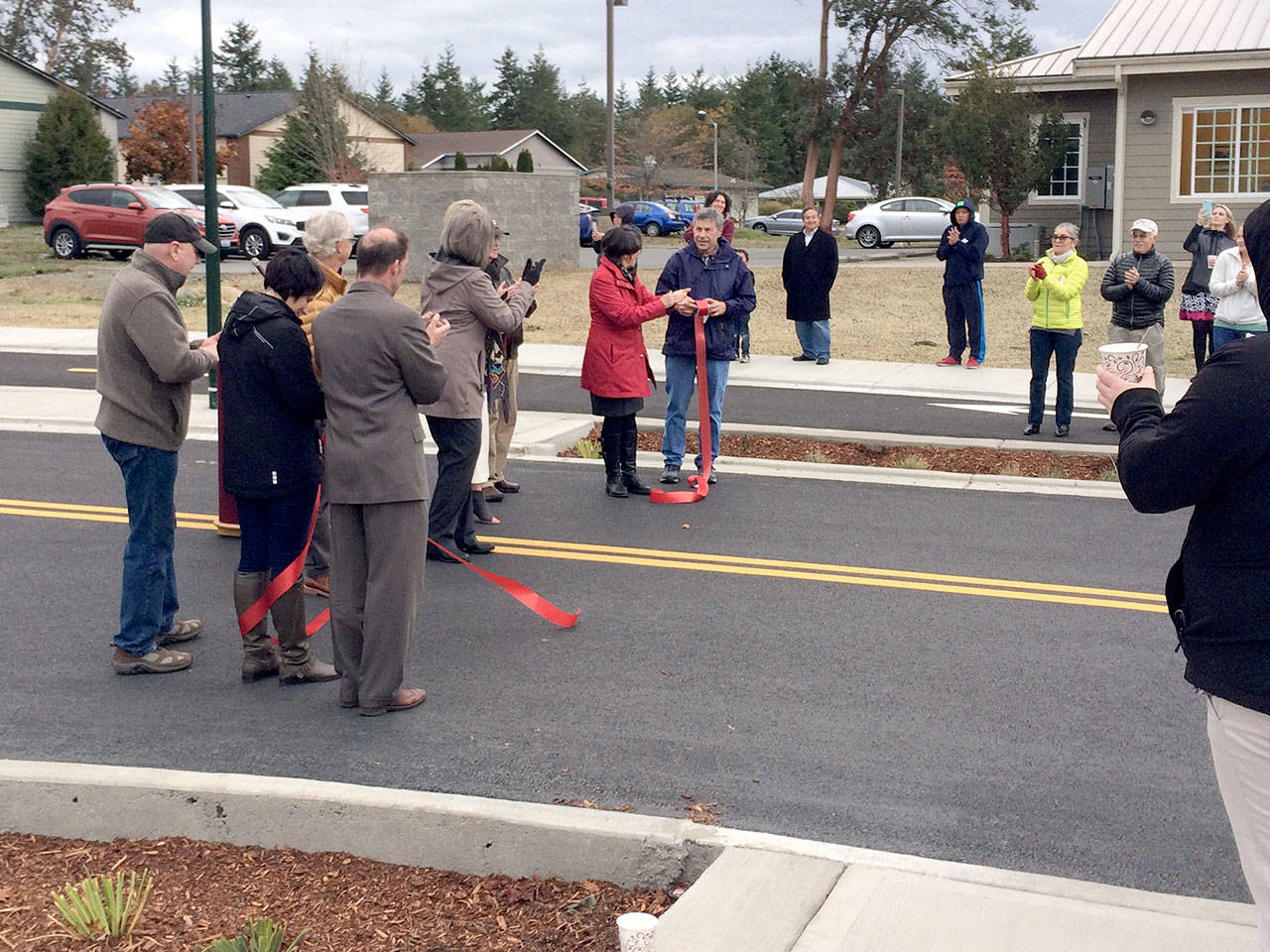 Port Townsend city officials, Jefferson County commissioners and community members gather for a ribbon-cutting for the new Rainier Street in Port Townsend on Wednesday morning. (Port Townsend Public Works Department)