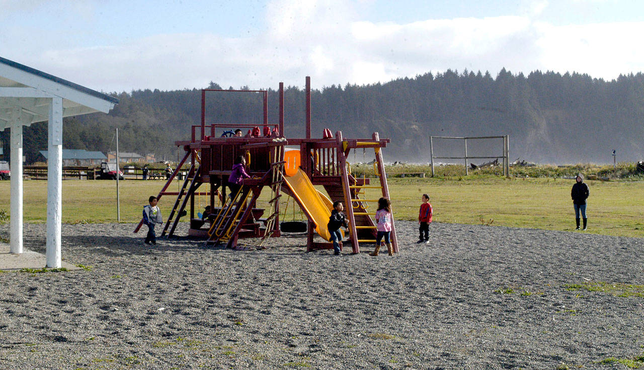 Kindergartners and first-graders from Quileute Tribal School play during afternoon recess Wednesday. The playground is about 15 feet above sea level. (Rob Ollikainen/Peninsula Daily News)