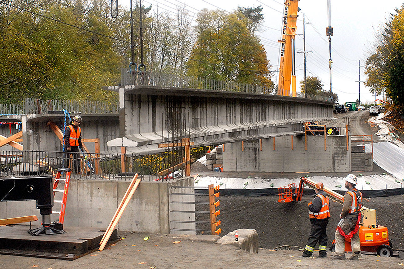 Construction crews set beams on new Old Olympic Highway bridge