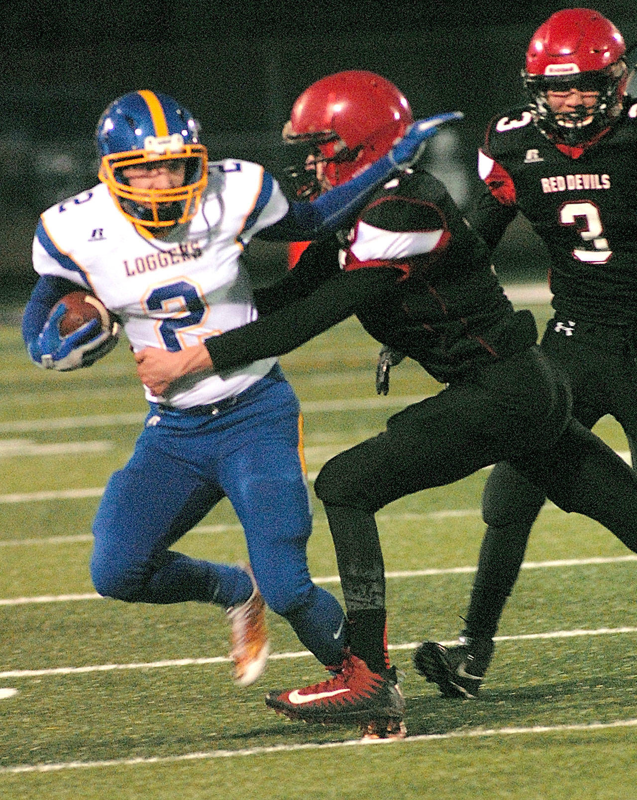 Keith Thorpe/Peninsula Daily News                                Crescent’s Robert Cox, left, tries to elude the defense of Neah Bay’s Jay Brunk, center, and Isaiah Knaus in the first quarter of Friday night’s playoff game at Spartan Stadium in Forks.