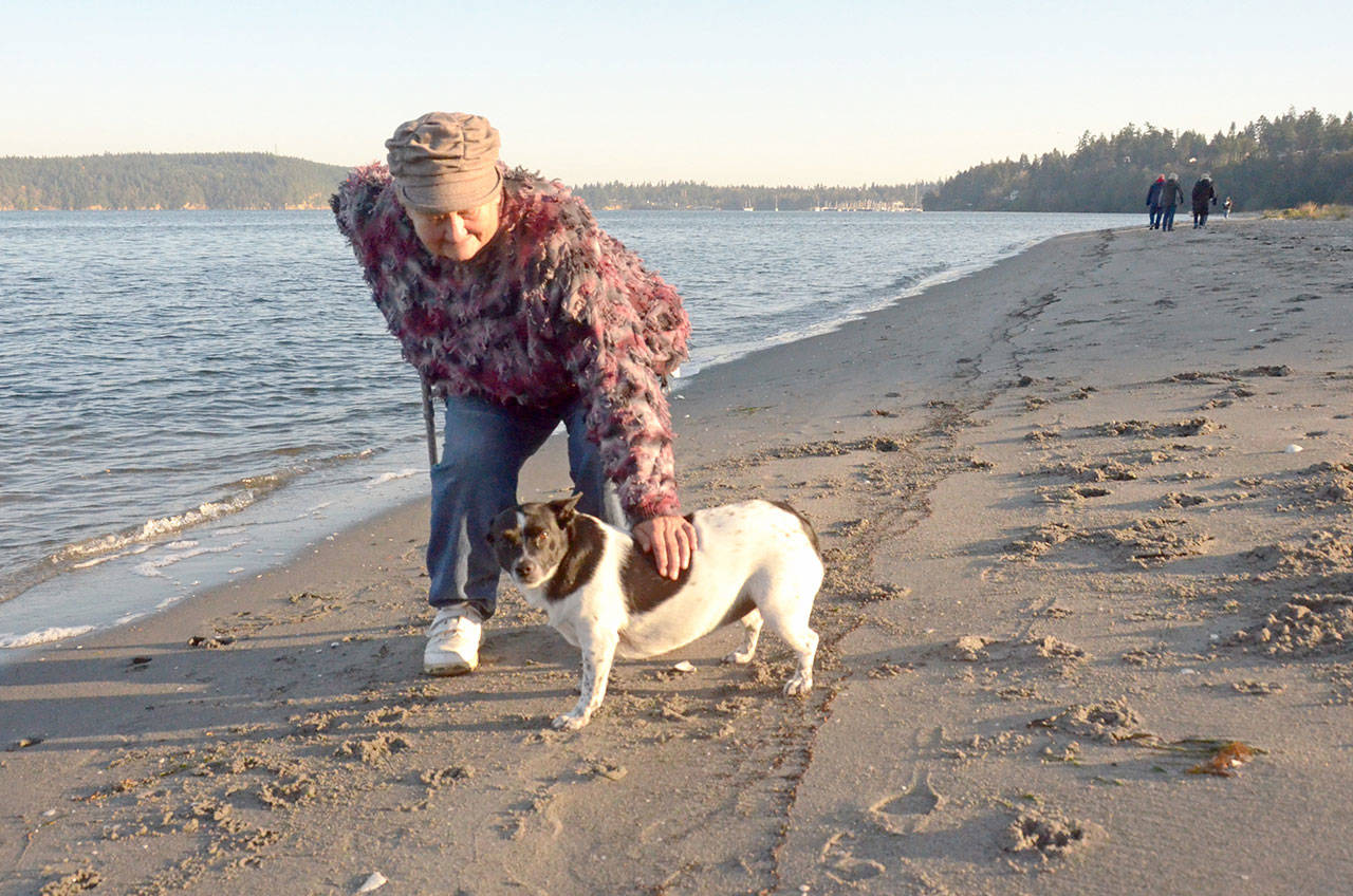 Sheri Hanson walks her dog Rosie along the beach near the mouth of Chimacum Creek, which is protected by a no-shooting area that was updated by the Jefferson County commissioners Monday. (Cydney McFarland/Peninsula Daily News)