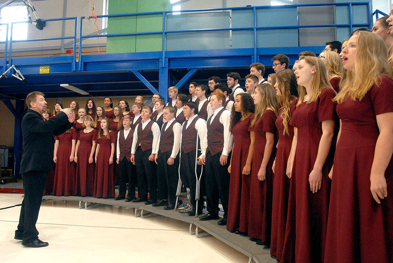 The Select Choir from Sequim High School, directed by John Lorentzen, sings “The Star-Spangled Banner” in the hanger at U.S. Coast Guard Air Station/Sector Field Office on Veterans Day. (Keith Thorpe/Peninsula Daily News)