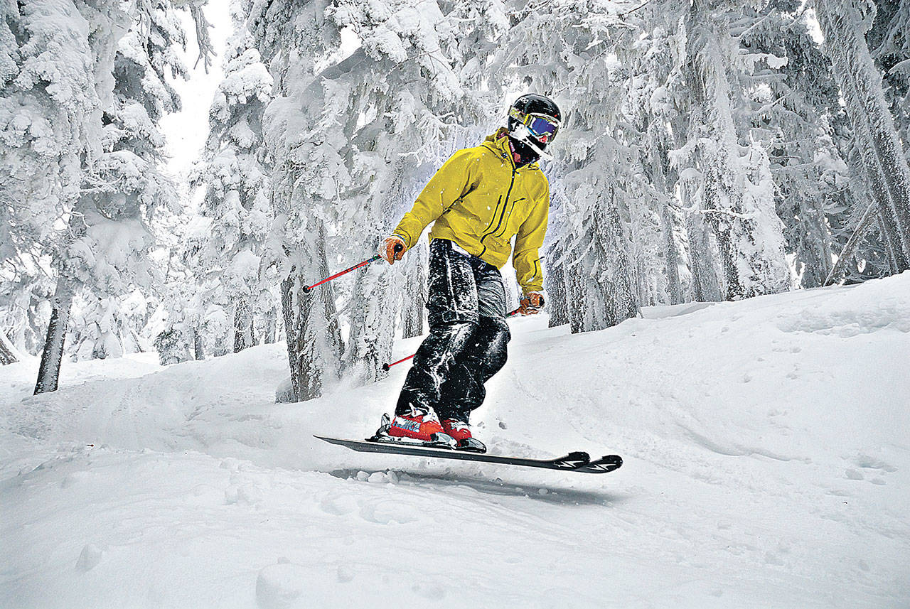 Alex Brown of Port Angeles jumps a few inches off the ground while skiing through the trees on Hurricane Ridge in 2013. (Peninsula Daily News)