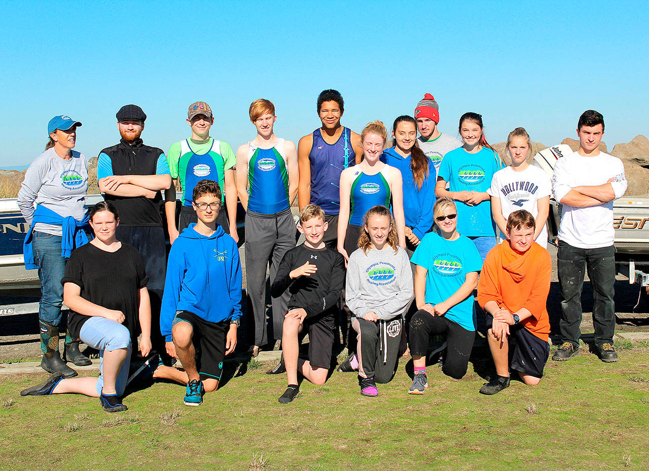 Olympic Peninsula Rowing Association rowers participating in the first-ever John Halberg Memorial Scrimmage. From left, back row, are coach Debby Swinford, Jake McGovern, Tyler Turner, Daniel Weaver Nathan Mishler, Emily Sirguy, Lisa Martin, Coach Calum Swinford, Ella Ventura, Lica Kennedy and Adain Feingold. From left, front, are Sophia Groves, Harrison Fulton, Will Roening, Shannon Callahan, Veronica Kennedy and Jack Feingold.