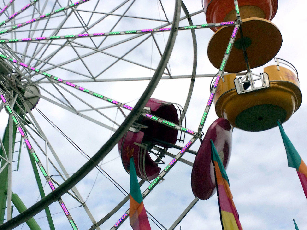 A gondola hangs open on a Ferris wheel after family members fell from it in May.