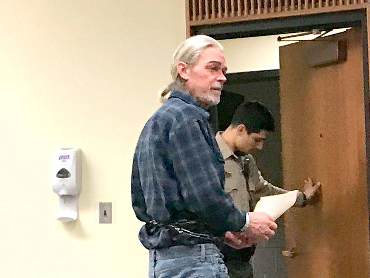 Gary Blanton headed back to jail Monday after a first appearance in Clallam County Superior Court for allegedly shooting at a neighbor’s house. (Paul Gottlieb/Peninsula Daily News)