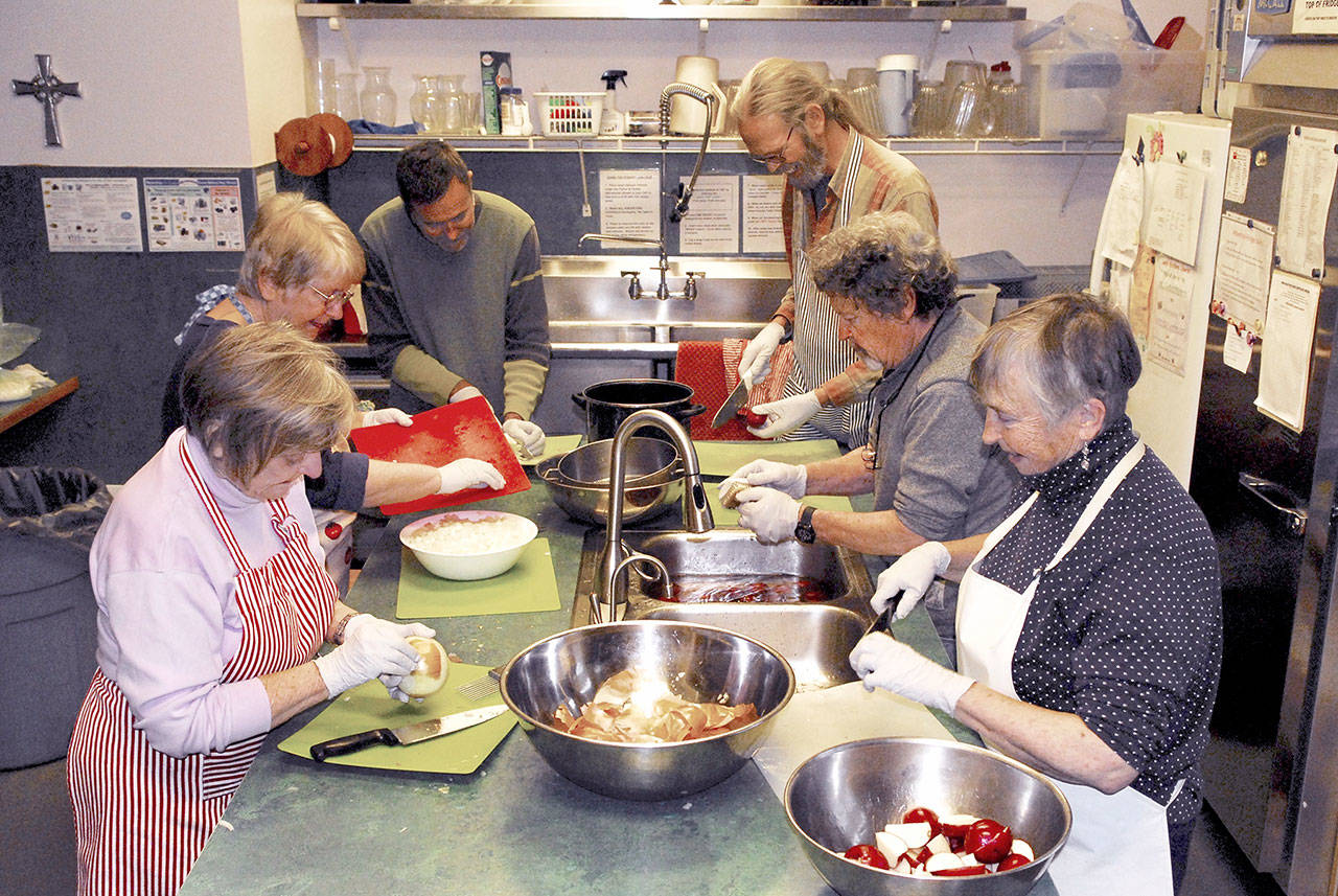Volunteers at St. Pauls Episcopal Church in Port Townsend busily prep vegetables for the seventh annual Thanksgiving meal, part of its Just Soup program. Dinner will be served today beginning at 11:30 a.m. Members of the Choppers include, from left, Allegra McFarland, Norma Van Valkenburg, Mark Adams, Barney Truman, Herb Tracy and Kathy Ryan. (Jeannie McMacken/for Peninsula Daily News)