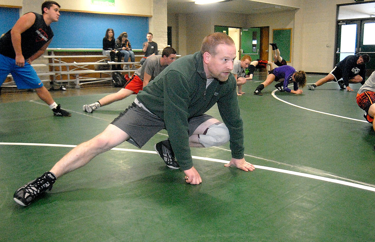 Keith Thorpe/Peninsula Daily News Port Angeles High School wrestling coach Rob Gale stretches with his team during a practice on Wednesday.