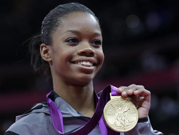 U.S. gymnast Gabrielle Douglas displays her gold medal during the artistic gymnastics women's individual all-around competitiion. The Associated Press