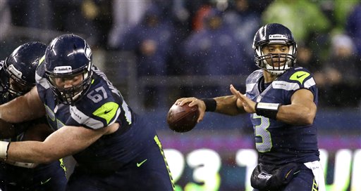 Seattle Seahawks quarterback Russell Wilson throws against the San Francisco 49ers in the first half of Sunday night's game at CenturyLink Field. Elaine Thompson/The Associated Press