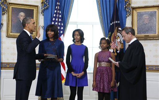 President Barack Obama is officially sworn-in by Chief Justice John Roberts in the Blue Room of the White House during the 57th Presidential Inauguration in Washington at noon (9 a.m. PST). Next to Obama are first lady Michelle Obama