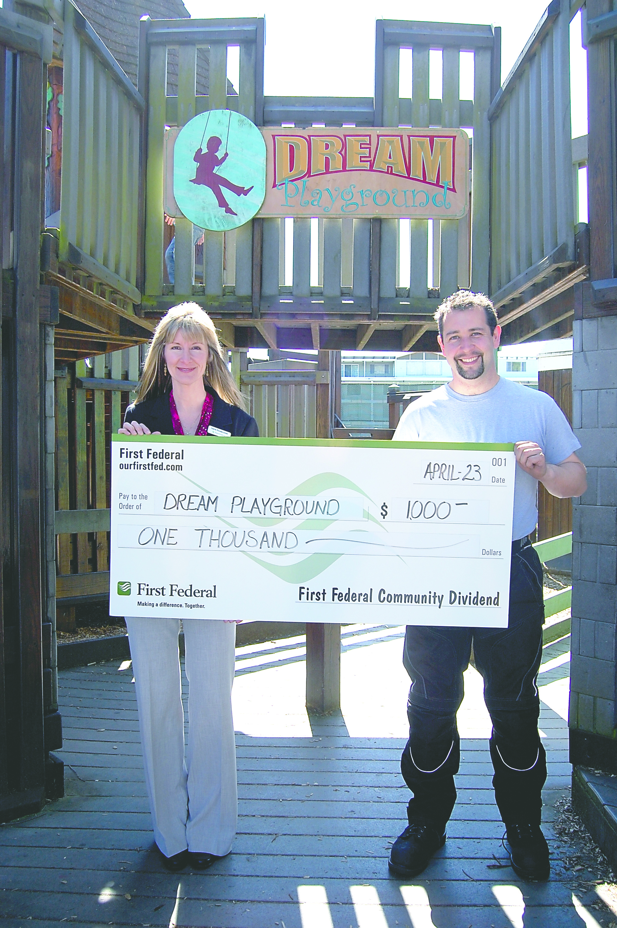 Dream Playground Foundation board member Justin Charon accepts a $1