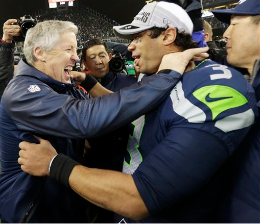 Seattle Seahawks head coach Pete Carroll celebrates with Seattle Seahawks' Russell Wilson. The Associated Press
