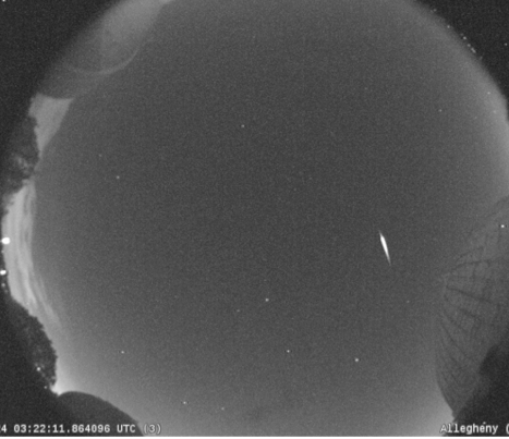 A brilliant meteor as bright as Jupiter streaks across the early morning sky Saturday in this NASA all-sky camera view of the Camelopardalid meteor shower. NASA
