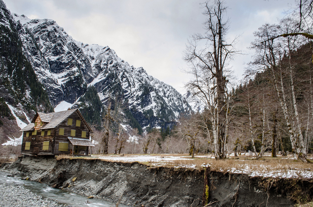 The Enchanted Valley Chalet teeters on the eroding bank of the Quinault River in Olympic National Park in April. Olympic National Park