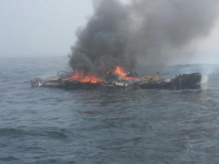 The 25-foot pleasure craft Dawn Trader is engulfed in flames following an engine fire three miles north of Neah Bay on Sunday. U.S. Coast Guard