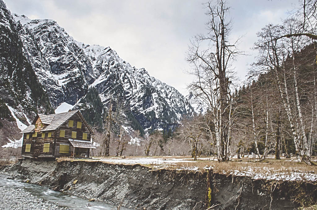 The Enchanted Valley Chalet teeters on the eroding bank of the Quinault River in Olympic National Park. National Park Service