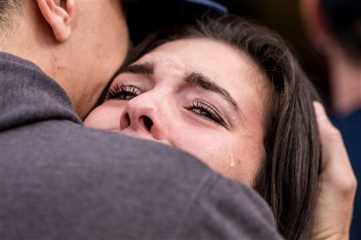 Tearful students are reunited with friends and family outside of a reunification center at Shoultes Christian Assembly Church near the scene of a school shooting that left two dead and four wounded at Marysville Pilchuck High School in Marysville. The Associated Press