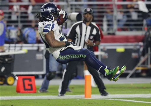 Seattle Seahawks running back Marshawn Lynch (24) leaps into the end zone for a touchdown against the Arizona Cardinals last Sunday. Where he has his right hand will cost him more than $11