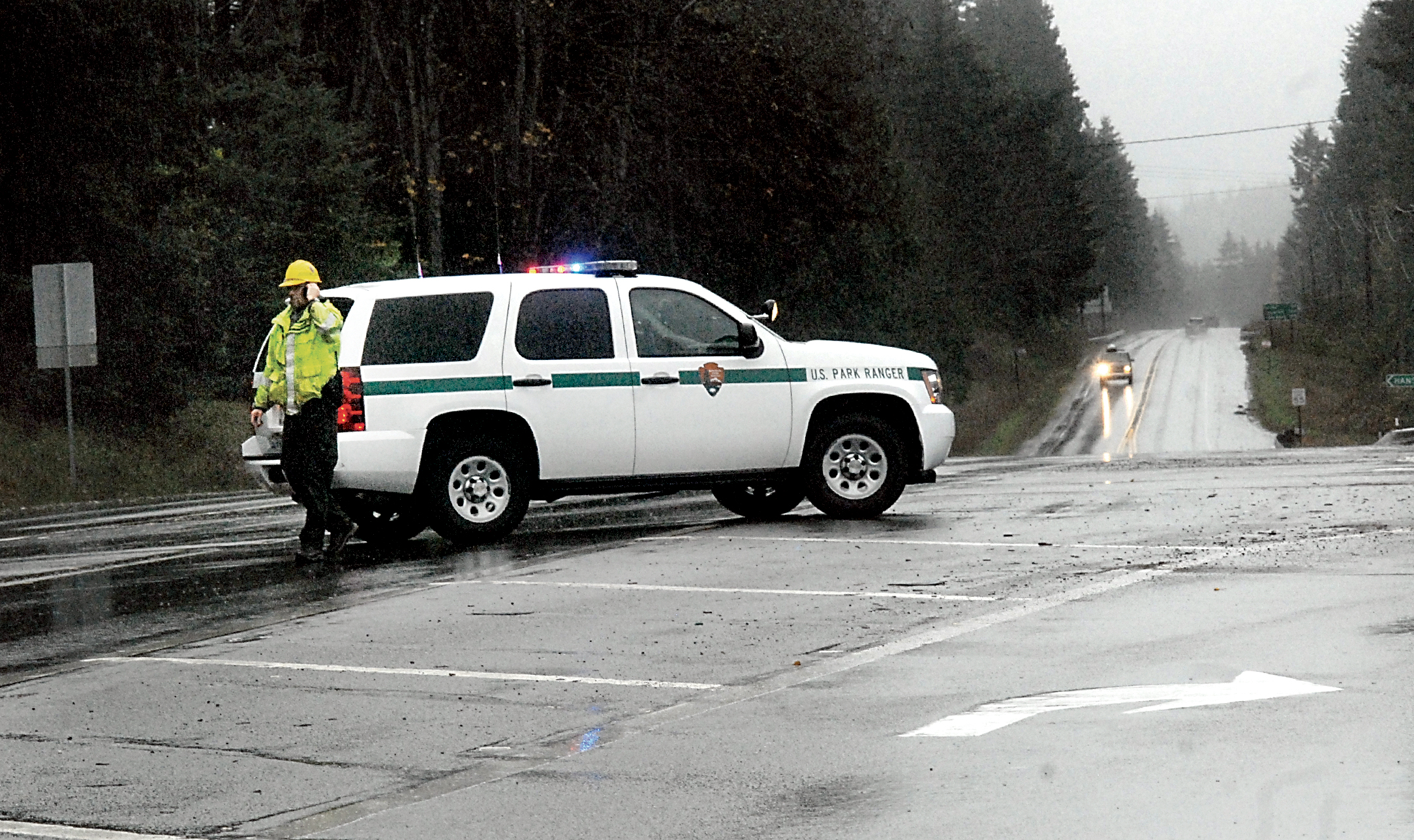 Olympic National Park East District Ranger Mark O'Neill keeps watch to direct traffic at the intersection of U.S. Highway 101 and state Highway 112 west of Port Angeles after park officials closed U.S. 101 around Lake Crescent because of an overflowing culvert after high winds and heavy rains overtook the area Tuesday. Keith Thorpe/Peninsula Daily News