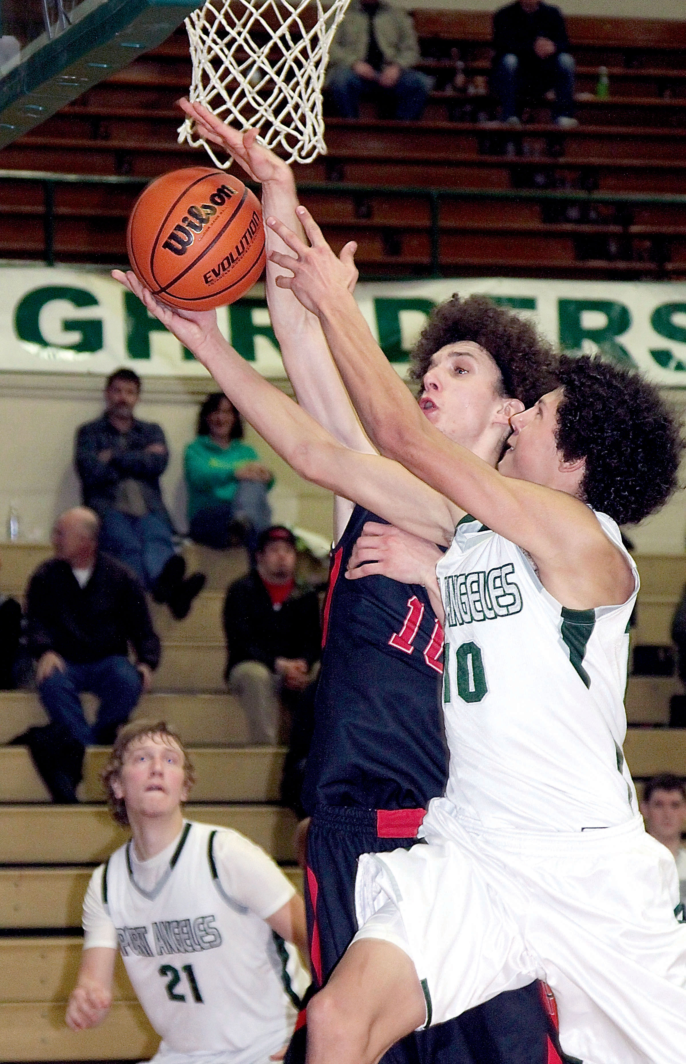 Port Angeles' Steven Lauderback has his shot blocked by Port Townsend's Paul Spaltenstein during the Roughriders' 57-54 win. Dave Logan/for Peninsula Daily News