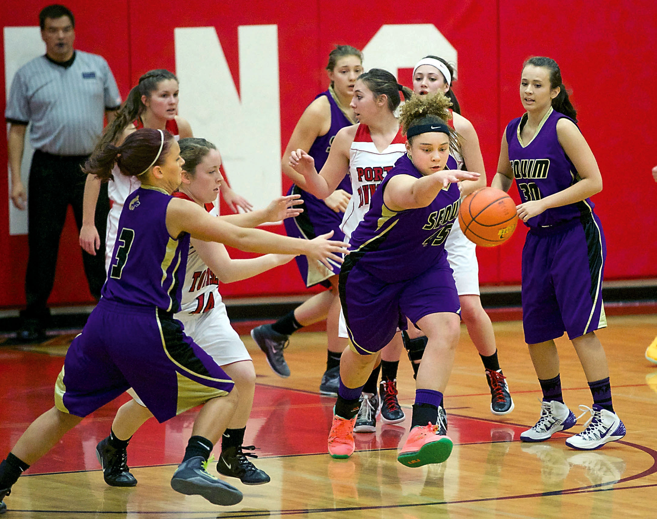 Sequim's Alexas Besand (45) tracks down a loose ball ahead of teammates Jordan Miller (30) and Hailey Lester (3) and Port Townsend's Megan Lee (14). Steve Mullensky/for Peninsula Daily News