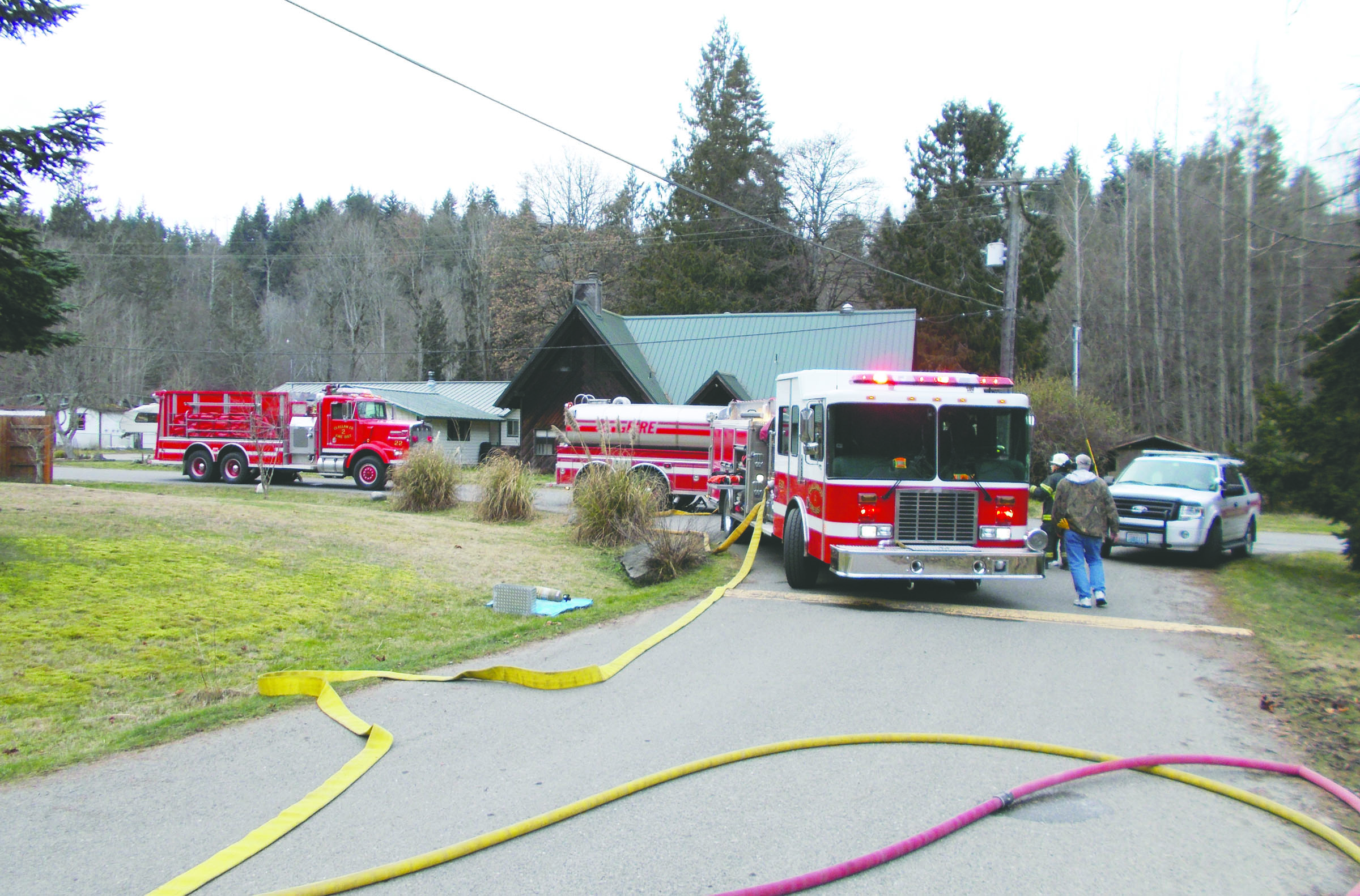 Units from Clallam County Fire District No. 2 respond to a structure fire on Rosewood Lane east of Port Angeles on Saturday. The cause was determined to be an electrical component in a TV-entertainment center. Clallam County Fire District No. 2