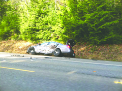 One of the two Jefferson County sheriff's cars is seen near Quilcene on U.S. Highway 101 Sunday. Brian Lewis