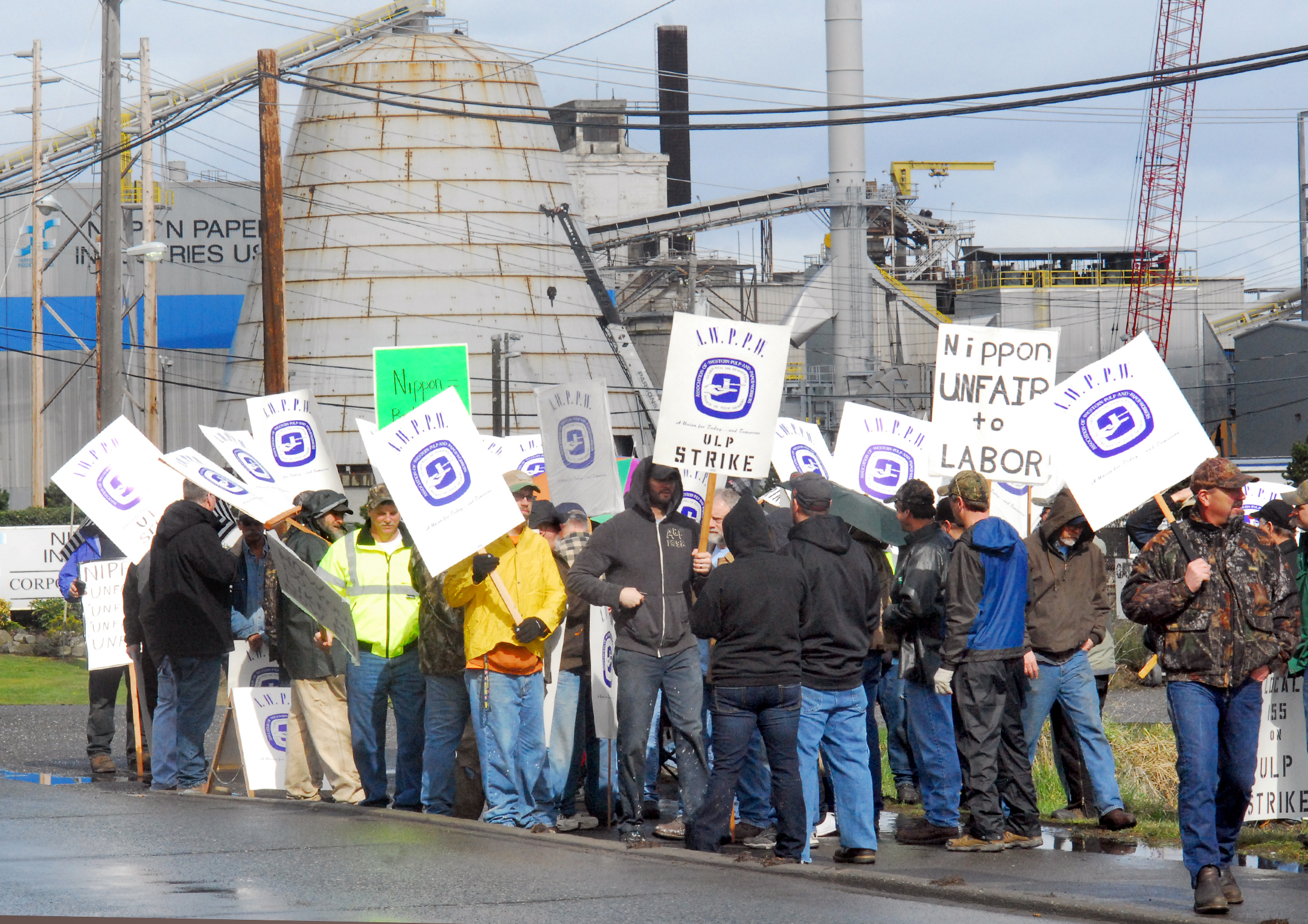Nippon Paper Industries USA workers gather outside the Port Angeles paper mill today after walking off the job because of a labor dispute. Keith Thorpe/Peninsula Daily News