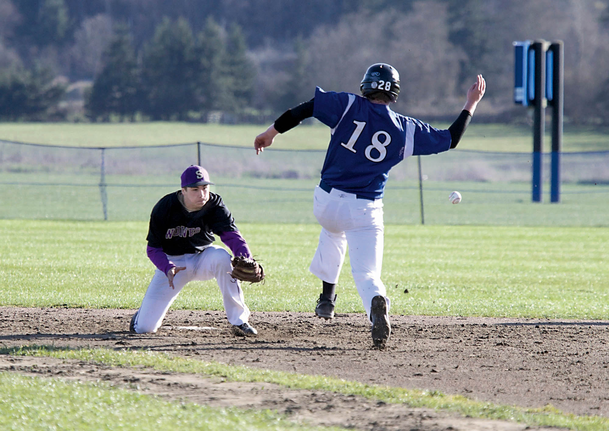 Chimacum's Lane Dotson (18) successfully steals second base as the ball arrives too late for Sequim's Tanner Rhodefer to make a play during a nonleague game at Chimacum High School. Steve Mullensky/for Peninsula Daily News