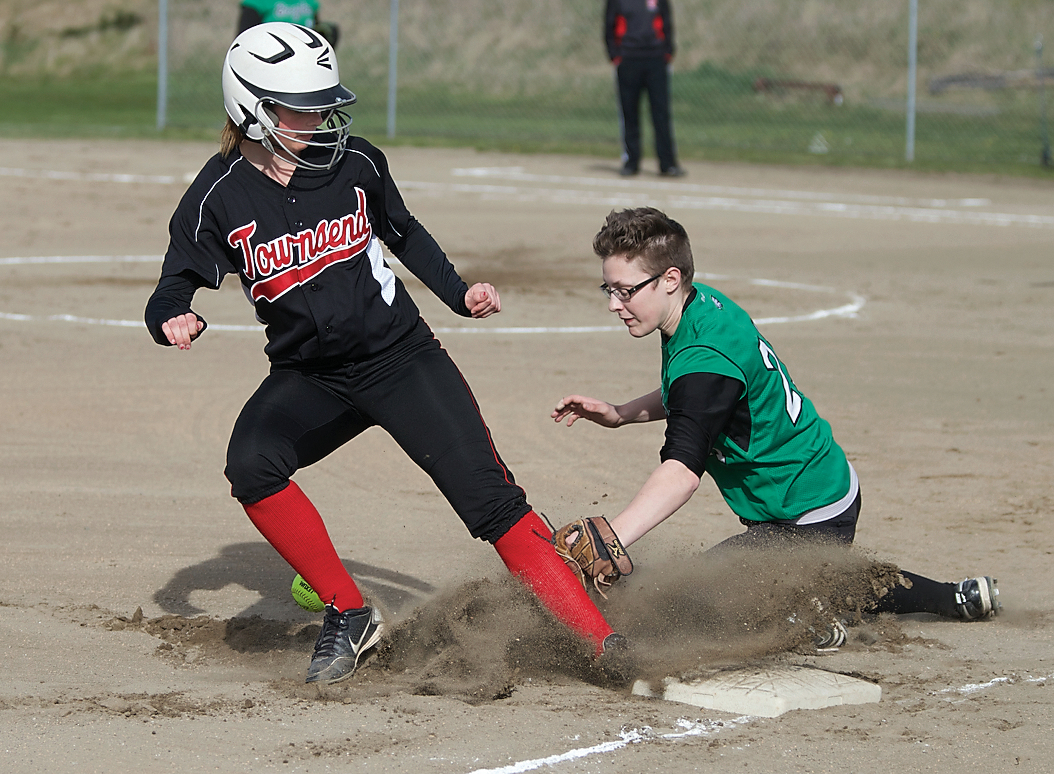 Port Townsend's Gen Polizzi does a stand-up slide into third as Klahowya's Amanda Shultz loses the ball. Steve Mullensky/for Peninsula Daily News