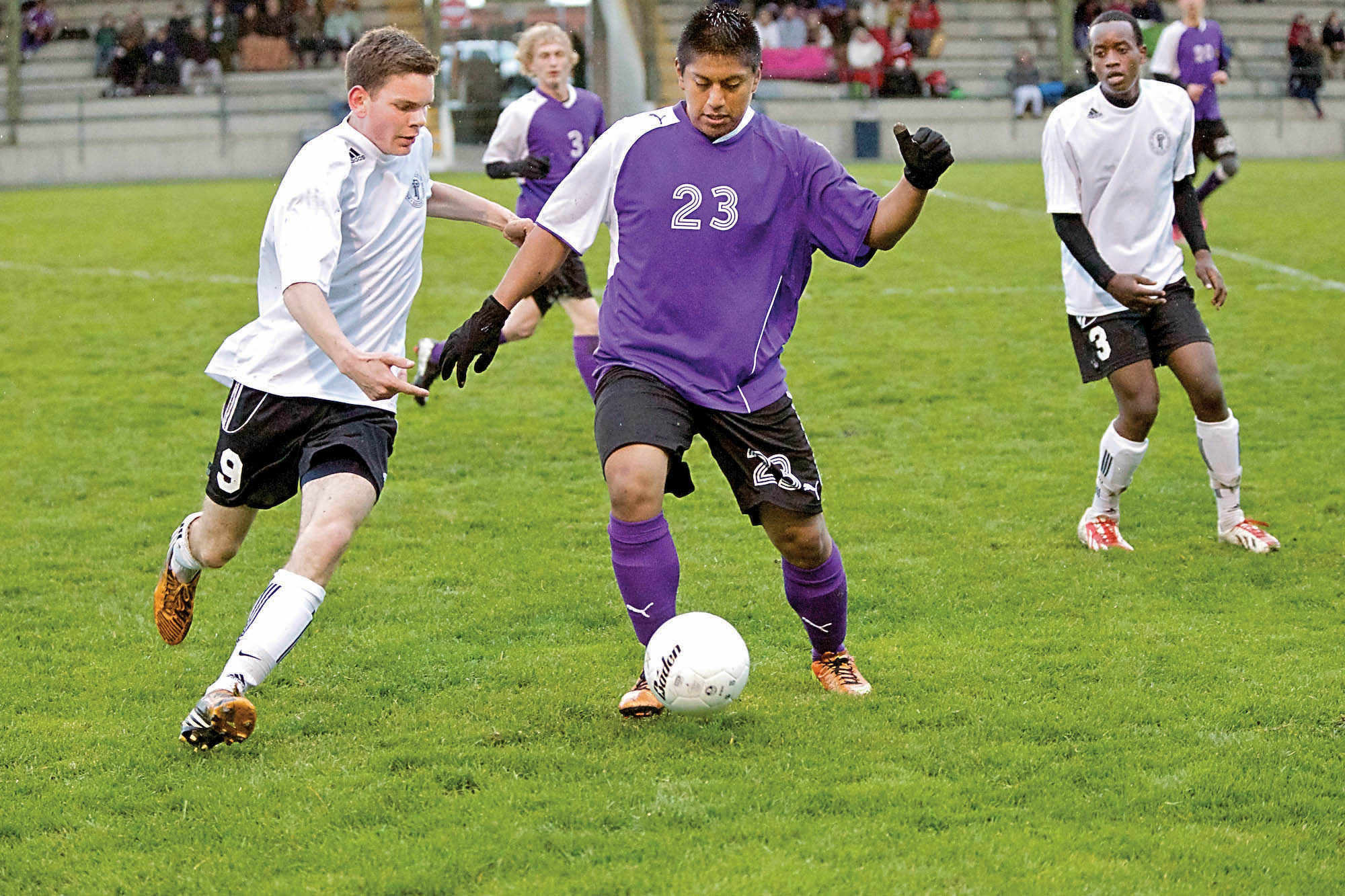 Port Townsend's Carl Delaire (9) and Sequim's Hector Baylon (23) vie for control of the ball. Steve Mullensky/for Peninsula Daily News