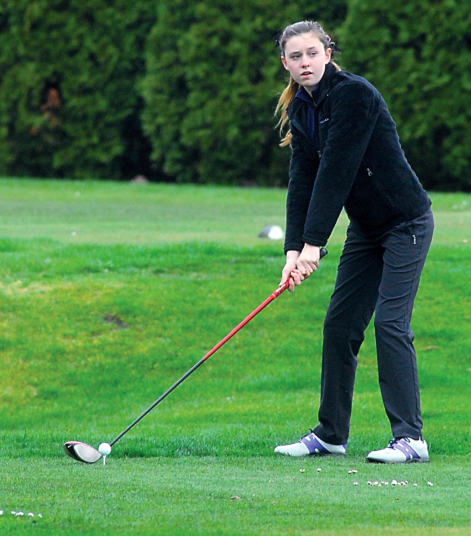 Sequim freshman Alex McMenamin sizes up her shot on the first hole at Cedars at Dungeness Golf Course against Port Angeles. Keith Thorpe/Peninsula Daily News