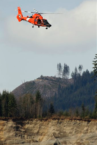 A Coast Guard MH-65 Dolphin helicopter from the Port Angeles air station