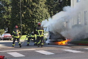 Firefighters attack an engine fire that soon enveloped a 1977 Volkswagen van at the corner of Lincoln and Seventh streets in Port Angeles on Sunday afternoon. Dave Logan/for Peninsula Daily News