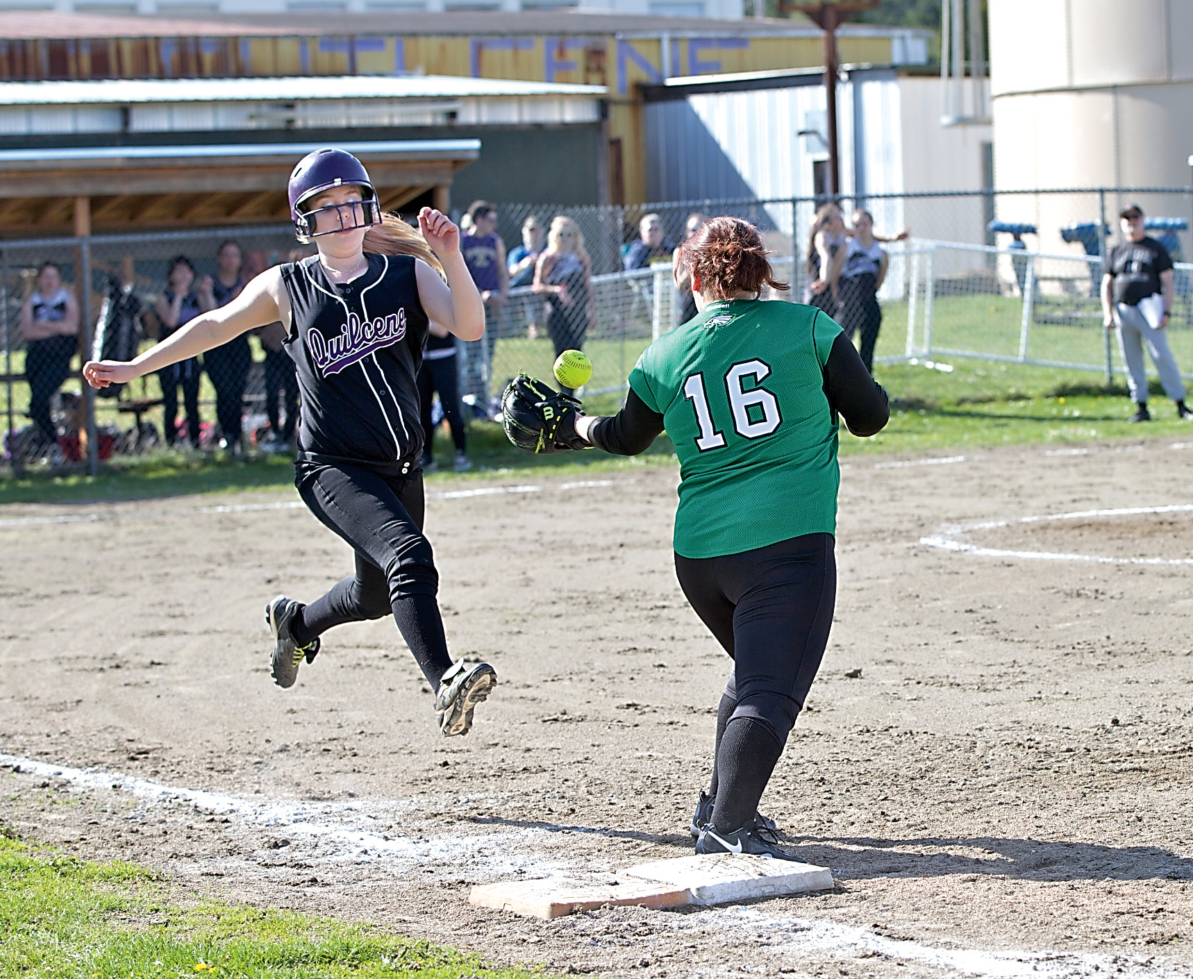 Quilcene's Emily Ward reaches safely on an error after Klahowya first baseman Natalie Barnes bobbled the ball. Steve Mullensky/for Peninsula Daily News