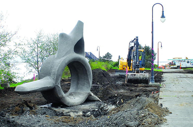 An excavator digs the area around the whale bone sculpture by Alex Anderson on Tuesday at Valley Creek Estuary Park in Port Angeles. Keith Thorpe/Peninsula Daily News