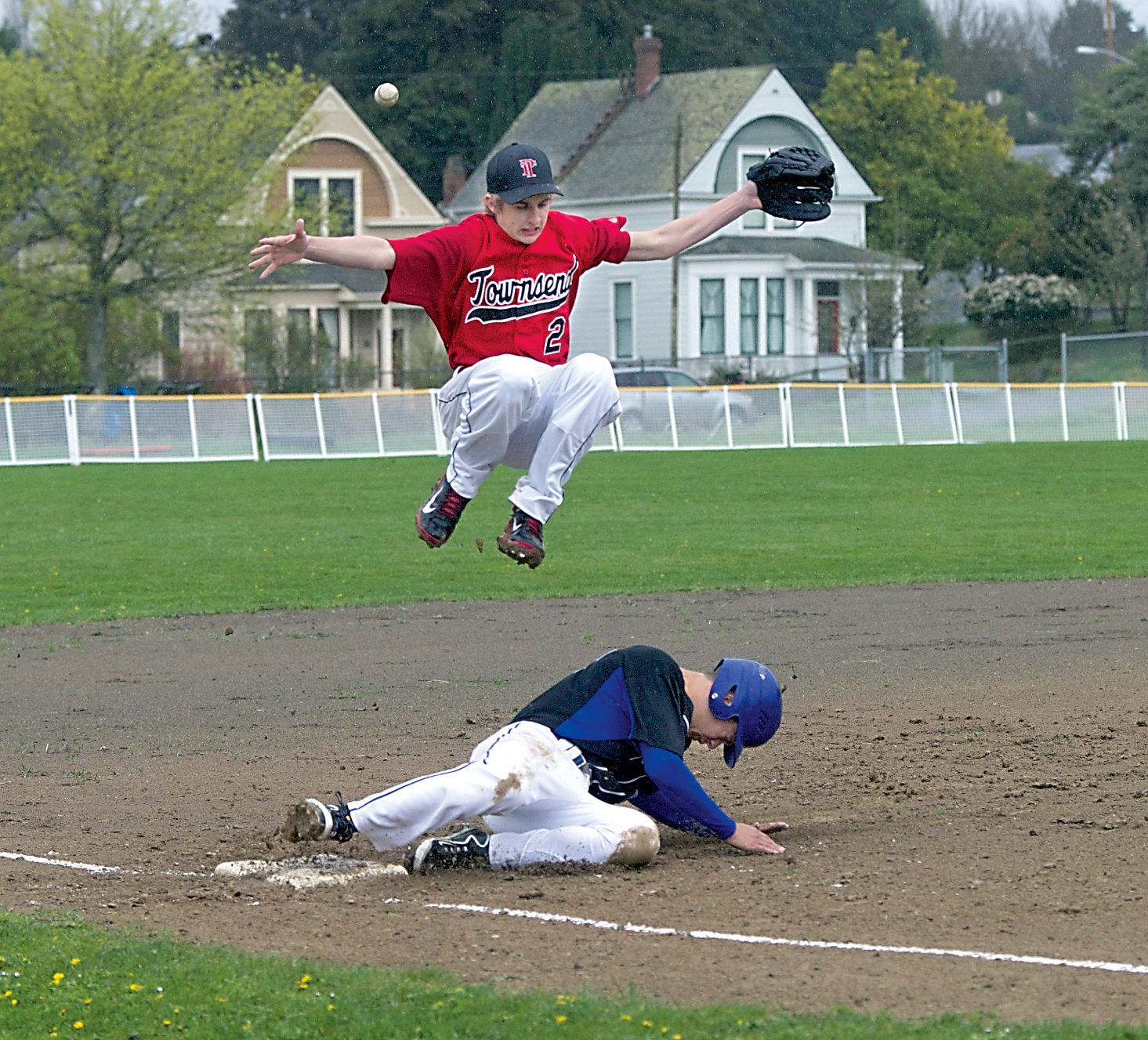 Port Townsend third baseman Jacob Ralls leaps to avoid colliding with North Mason's Hunter Hohmann. Steve Mullensky/for Peninsula Daily News