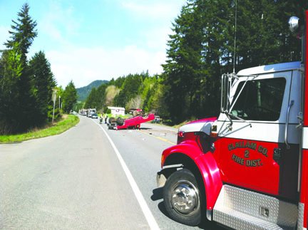 The 1998 Toyota Tacoma pickup driven by Bill Gallauher of Port Angeles lies on its roof after Gallauher rolled the vehicle after swerving to avoid hitting a van in front of him