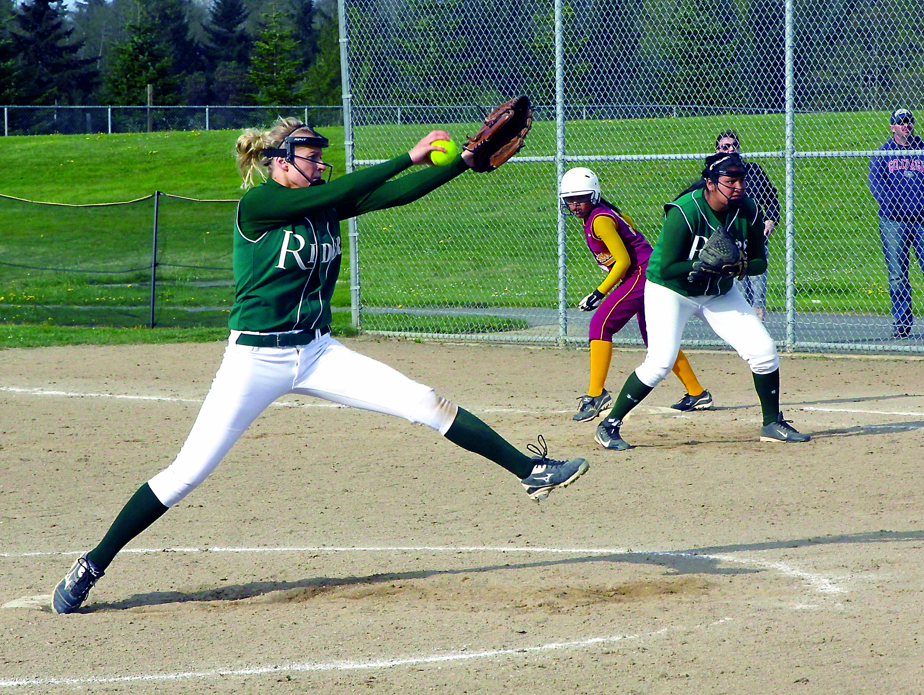 Port Angeles pitcher Sarah Steinman readies her delivery as first baseman Nizhoni Wheeler and a Kingston base runner look on during a game at Dry Creek Elementary School Dave Logan/for Peninsula Daily News