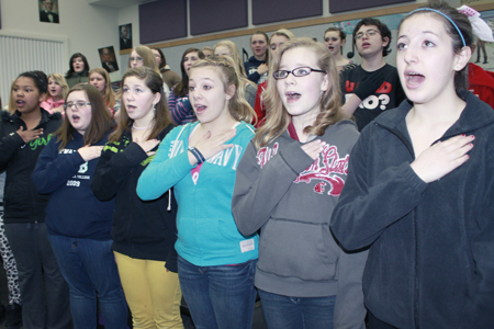 Stevens choir members practice the national anthem. Front row