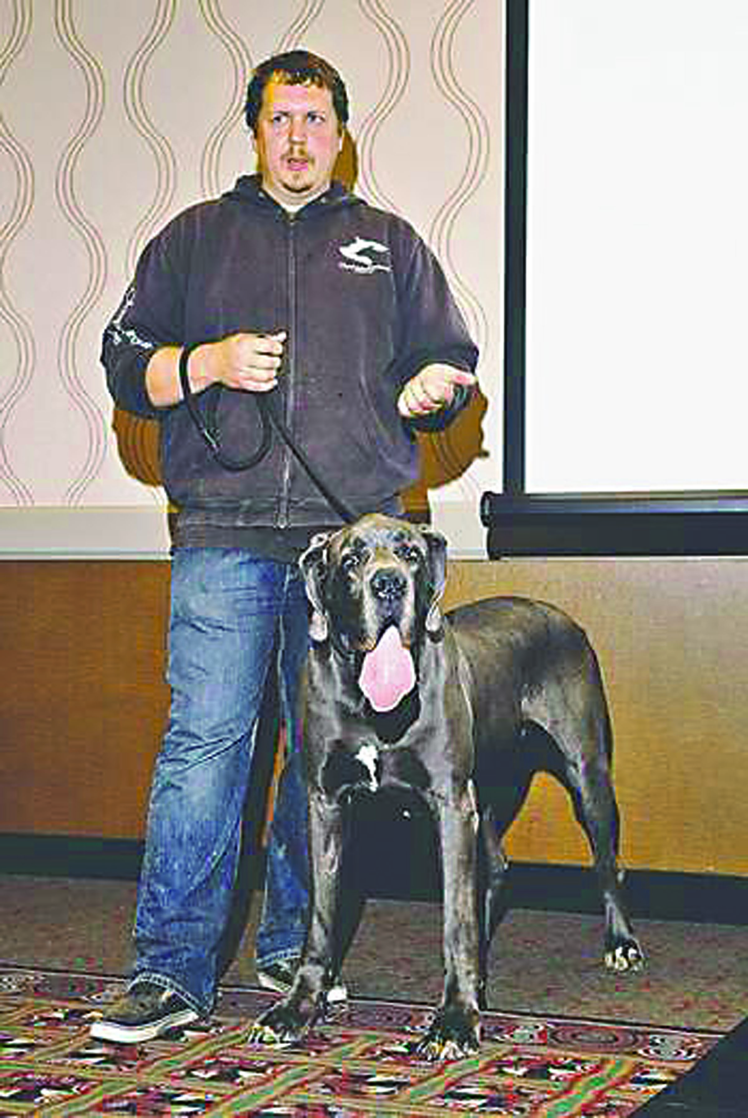 Steve Markwell is shown with one of his shelter dogs giving a talk in Port Angeles in 2012. Peninsula Daily News