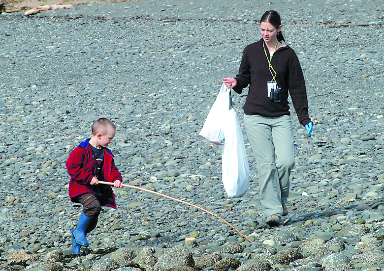 Angela Wade of Port Angeles carries trash bags