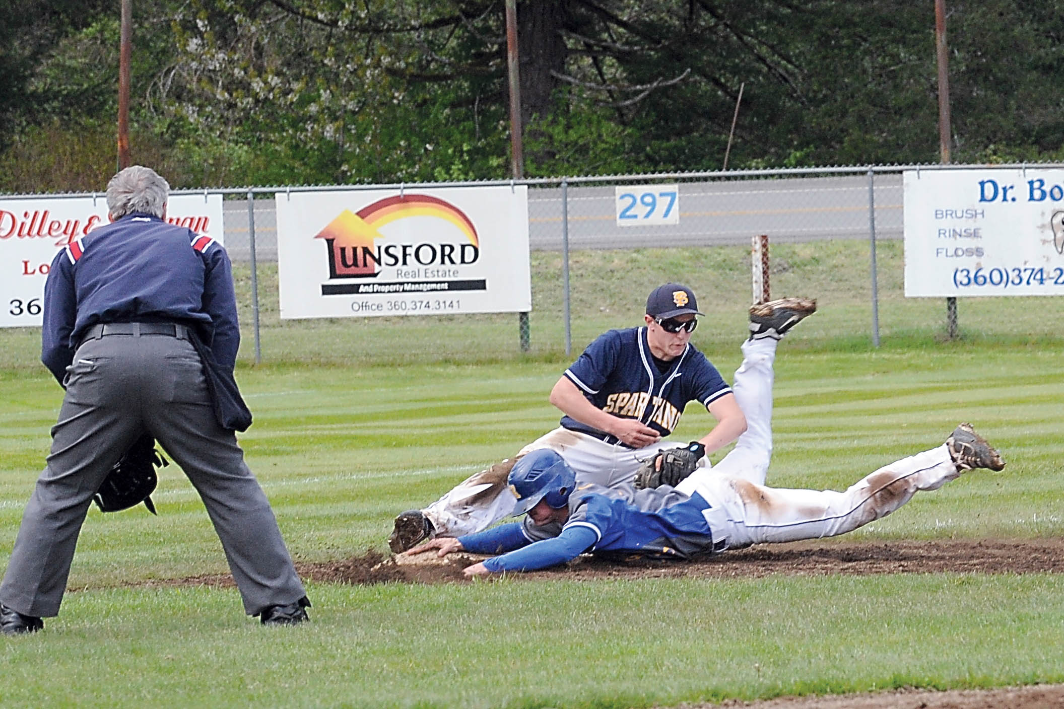 Rochester's Dustin Wilson slides safely into third with a triple while Forks' Caleb Adams applies the late tag at the base. Rochester took both games of a doubleheader with the Spartans 12-7 and 8-3. Lonnie Archibald/for Peninsula Daily News