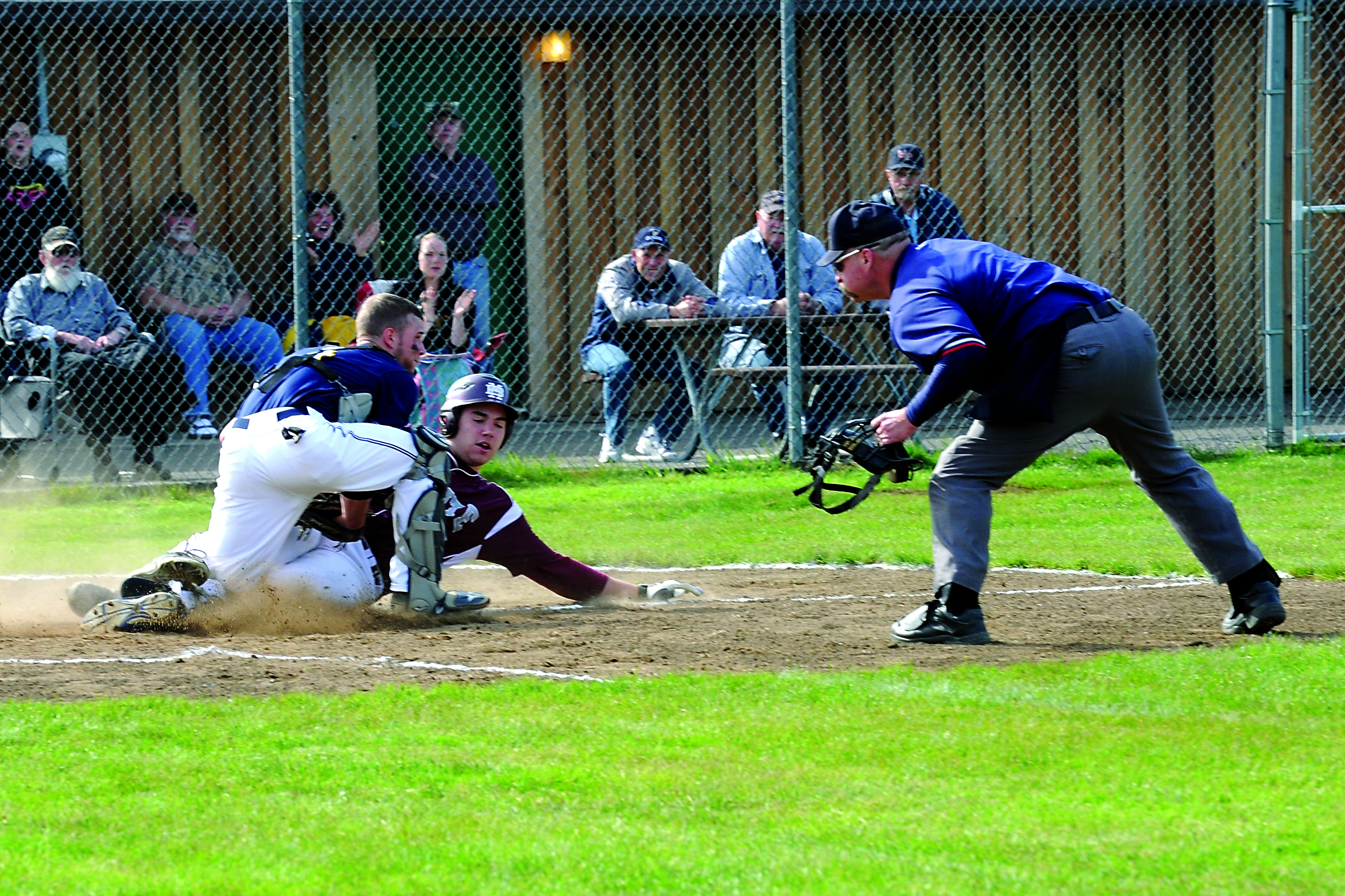 Forks catcher Reece Hagen tags a Montesano base runner out at home plate in the Spartans 4-3 win over the Bulldogs. Lonnie Archibald/for Peninsula Daily News