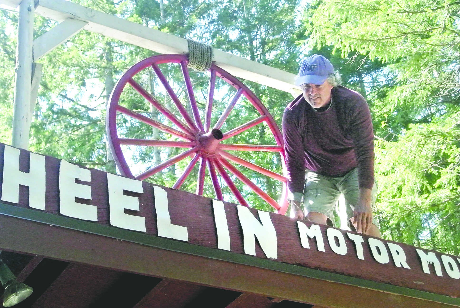 Rick Wiley hangs the sign for the Wheel-In Motor Movie
