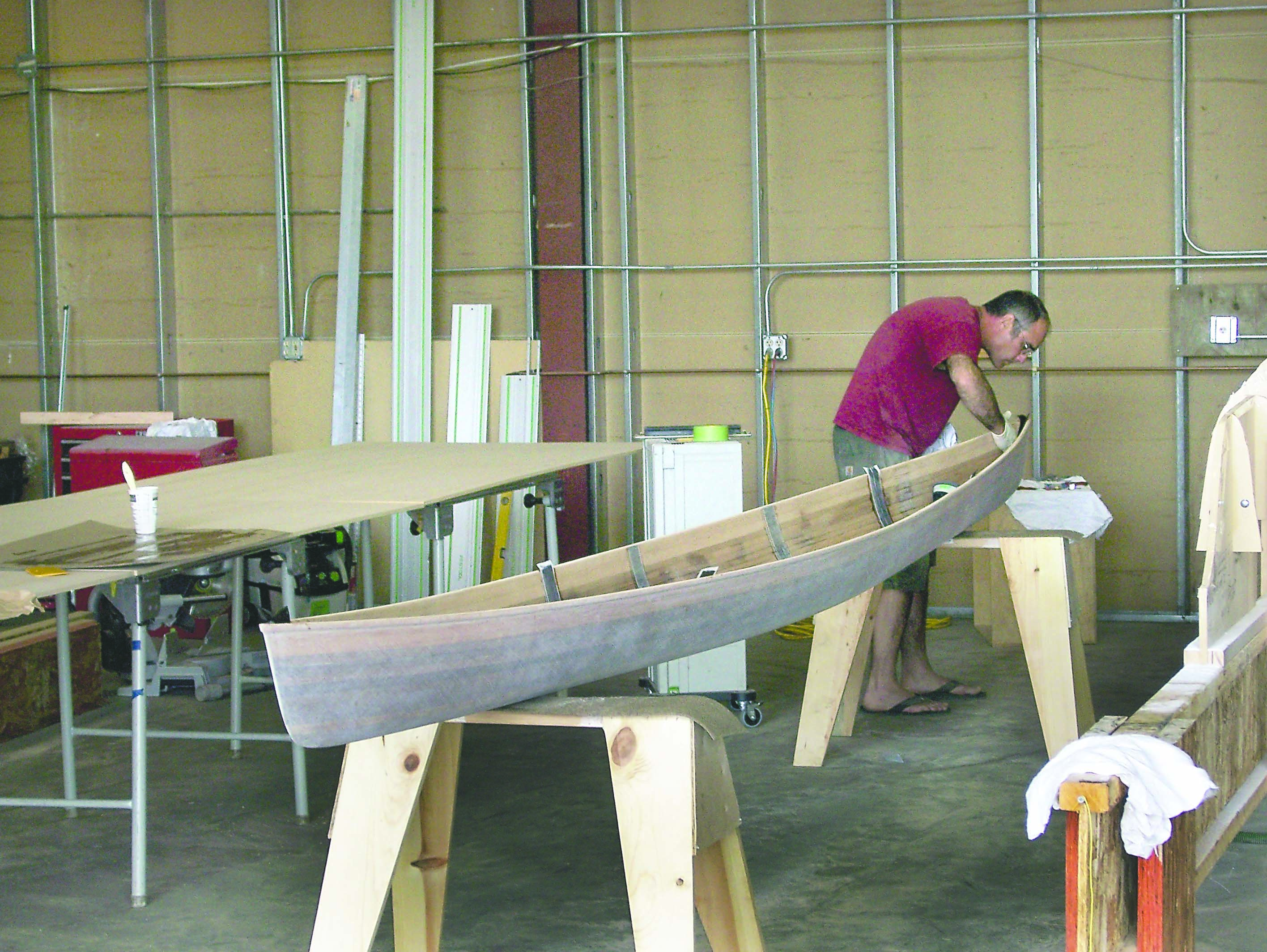 Eric Bert begins the fiberglass and epoxy process on one of the three war canoes he’s building in his new plant west of Port Angeles.  -- Photo by David G. Sellars/for Peninsula Daily News