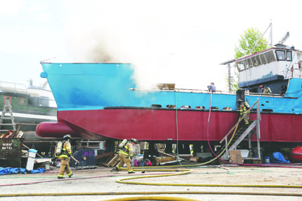 A fire on a commercial fishing vessel is extinguished Monday in the Port Townsend Boat Haven. Crystal Craig